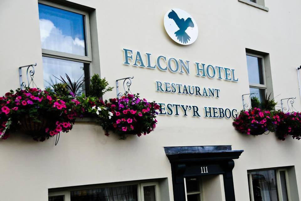 a building with a sign on the front of it at Falcon Hotel in Carmarthen