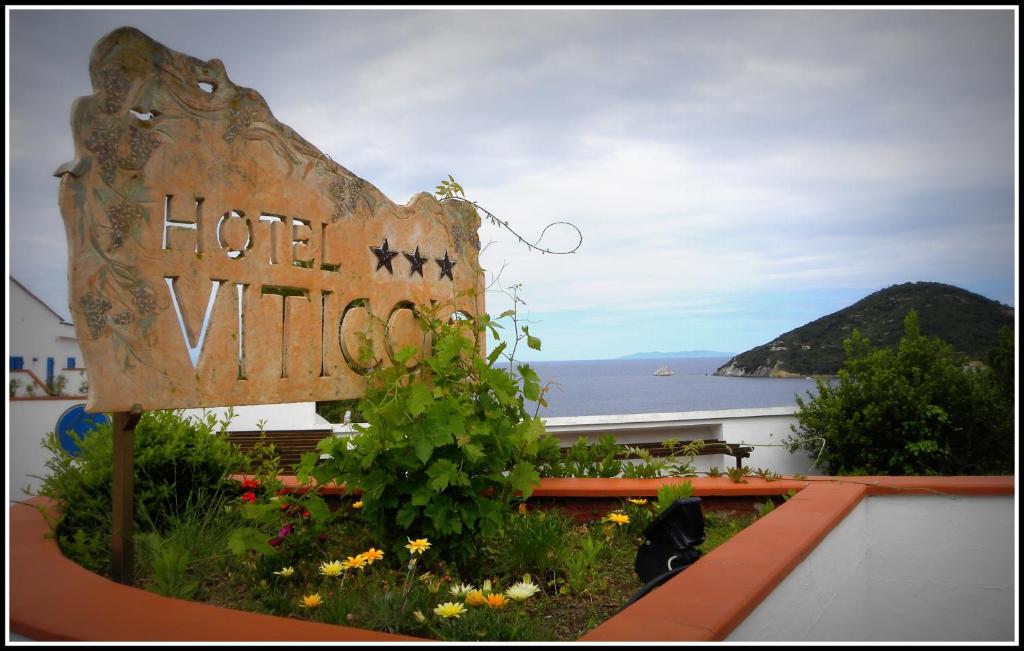 a sign for a hotel with a view of the ocean at Hotel Viticcio in Portoferraio