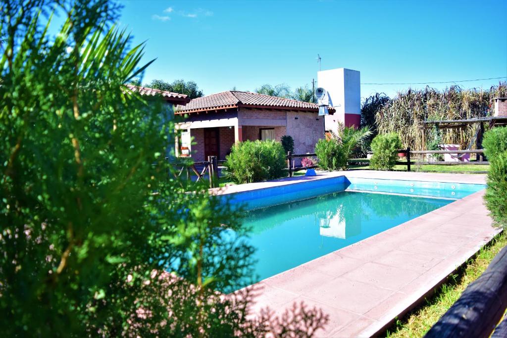 a swimming pool in the yard of a house at Cabañas Villa del Sol in Salta