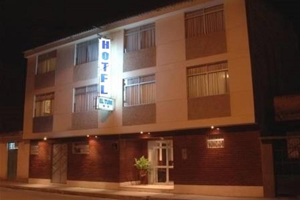 a hotel building with a sign on it at night at Hotel El Tumi 2 in Huaraz