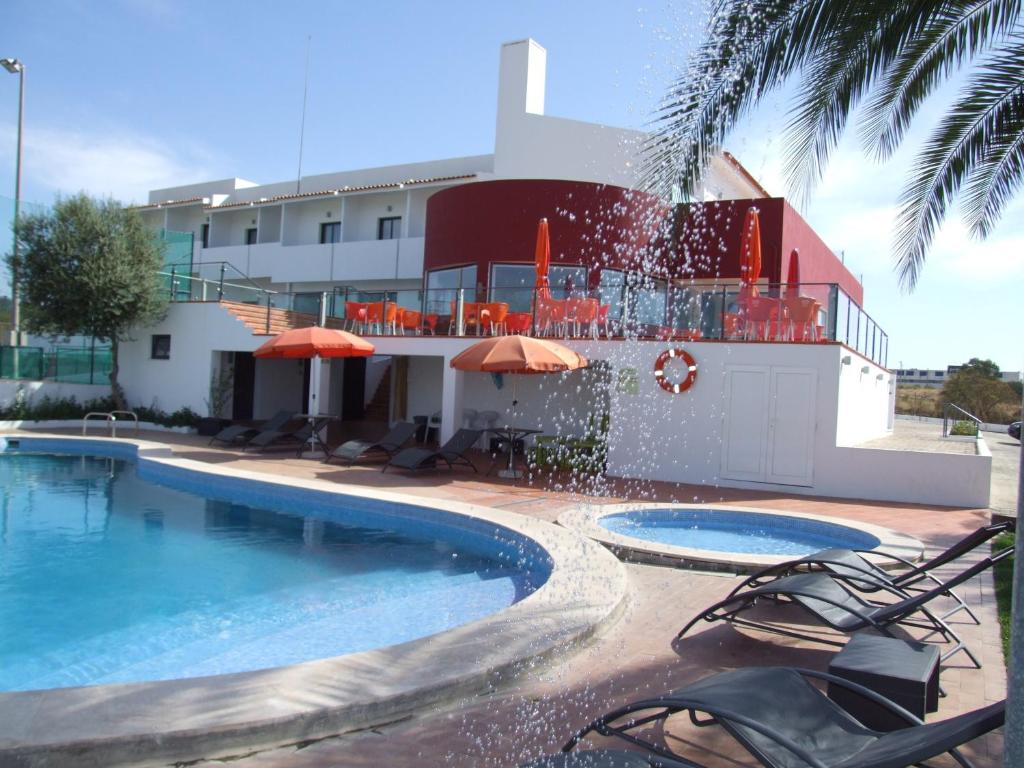 a swimming pool in front of a building at Casa Do Vale Hotel in Évora