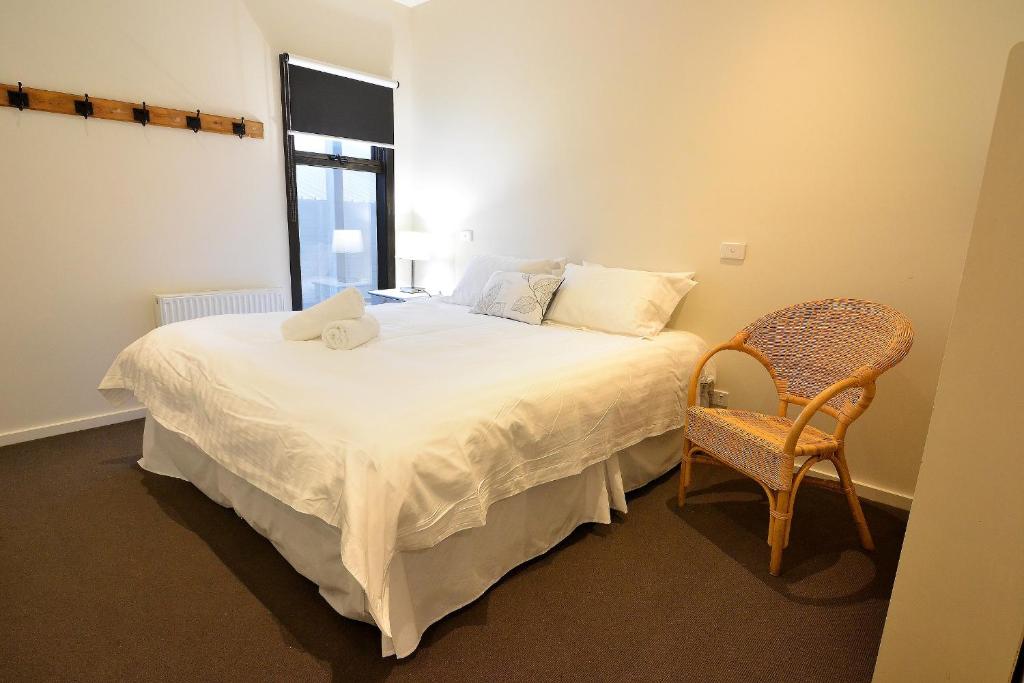 a bedroom with a bed with a stuffed animal on it at Apartment K2 05 in Mount Buller