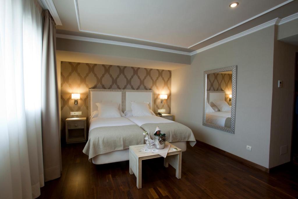 Säng eller sängar i ett rum på Hotel Os Olivos