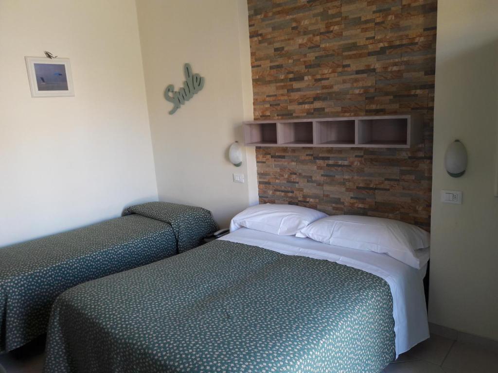Postel nebo postele na pokoji v ubytování Hotel Mariani