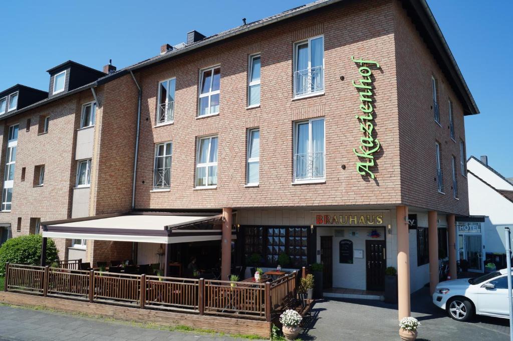 a large brick building with a sign on it at Akazienhof Hotel & Brauhaus in Cologne