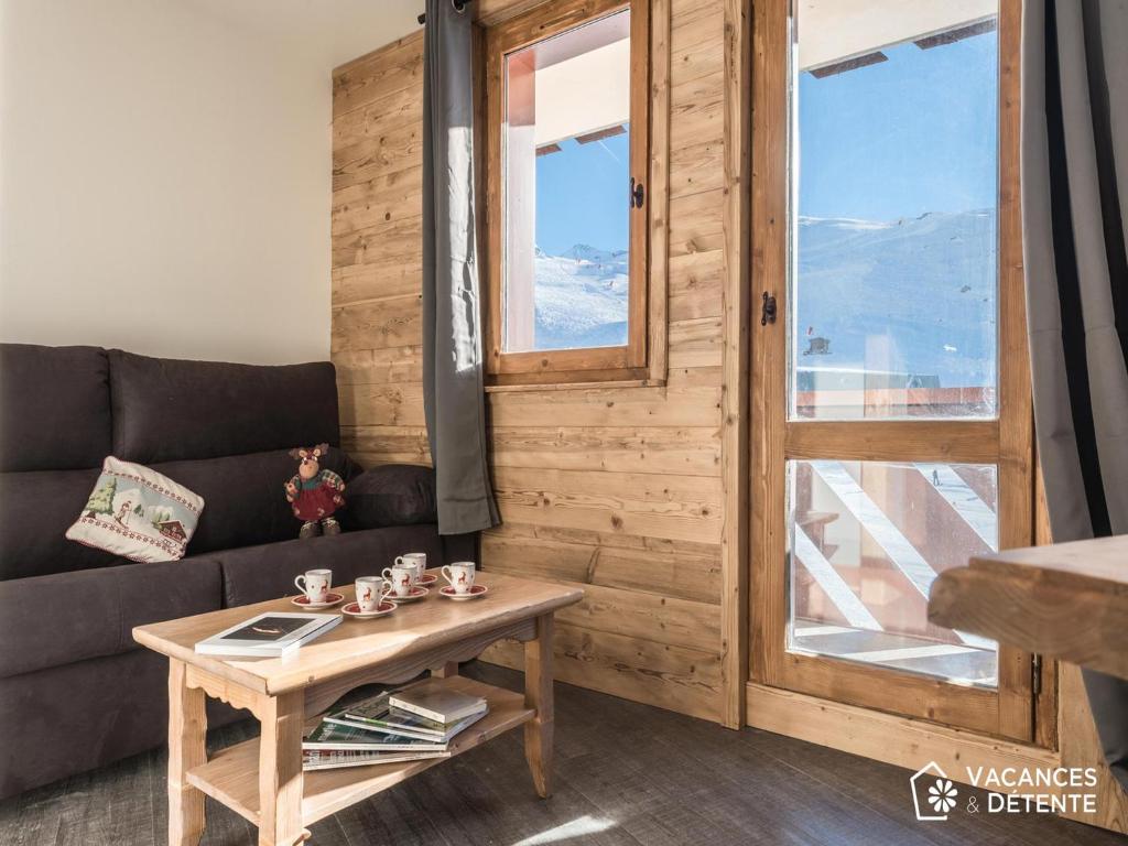 a living room with a couch and a table at Nazca C6 in Val Thorens