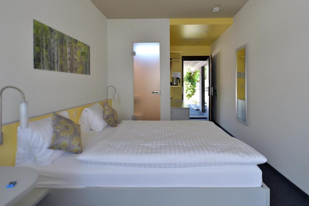 Postel nebo postele na pokoji v ubytování Hotel Sommerau