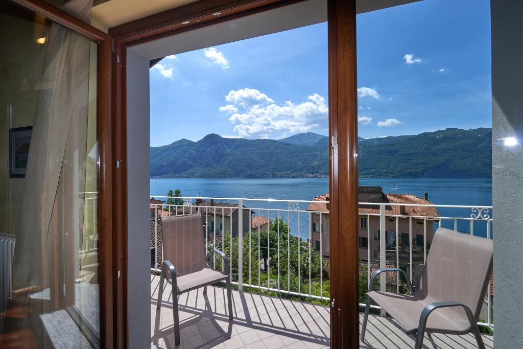 a balcony with a view of a lake and mountains at B&B-FORESTERIA Casa Della Musica Lake Como in Mandello del Lario