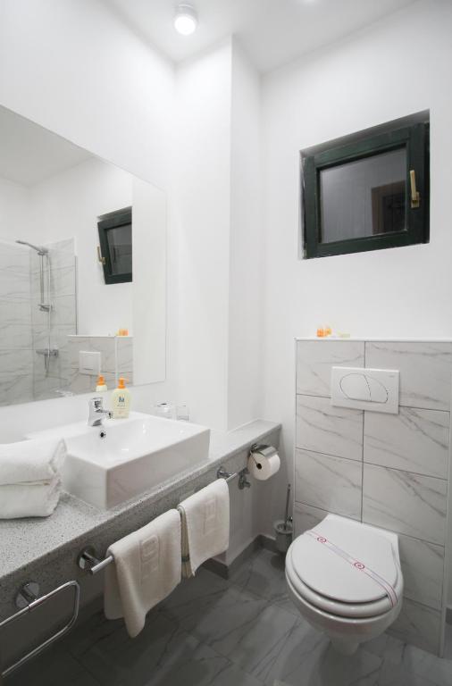 a bathroom with a toilet and a sink at Hotel Danica in Petrovac na Moru
