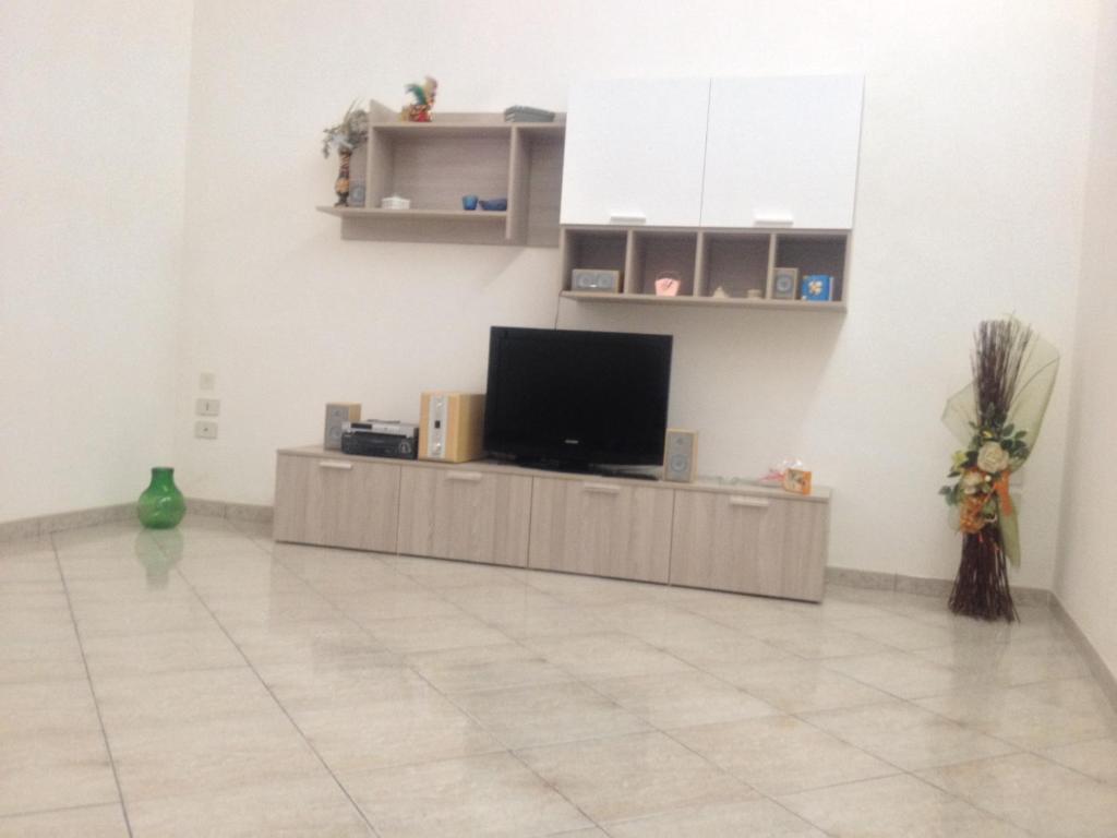 een woonkamer met een tv en een tegelvloer bij Apartment Cara Sibilla in Marsala