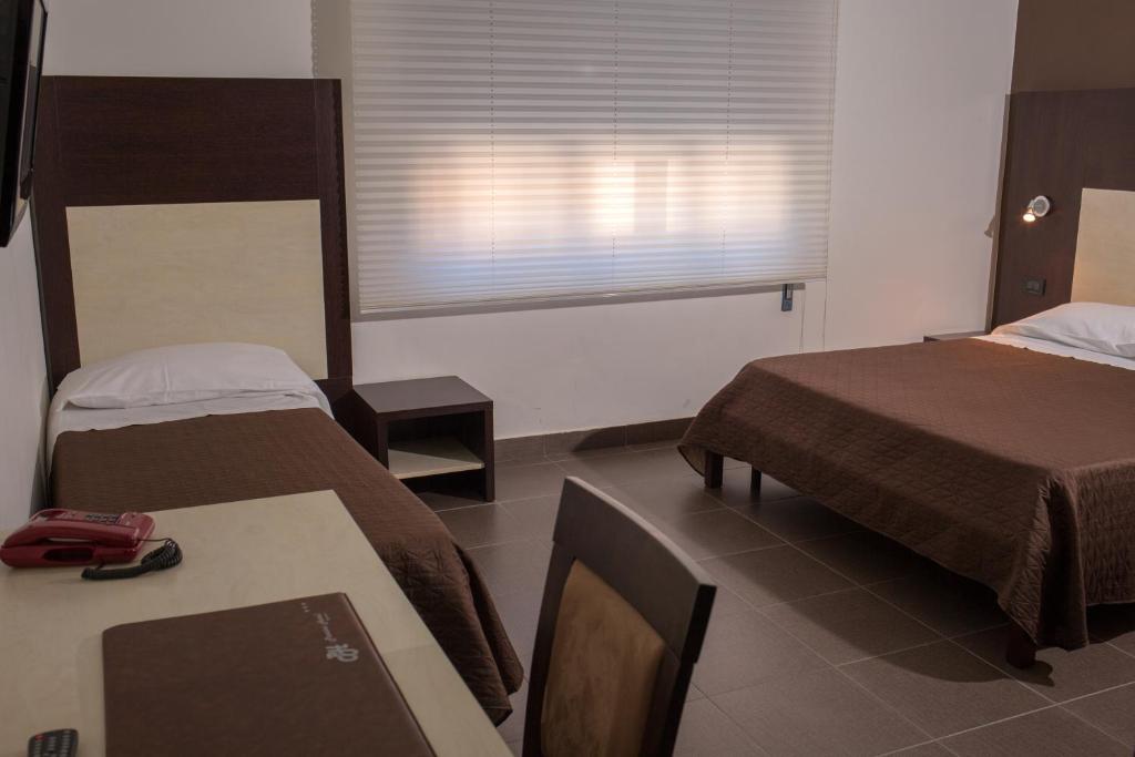 Postel nebo postele na pokoji v ubytování Pansini Hotel Residence
