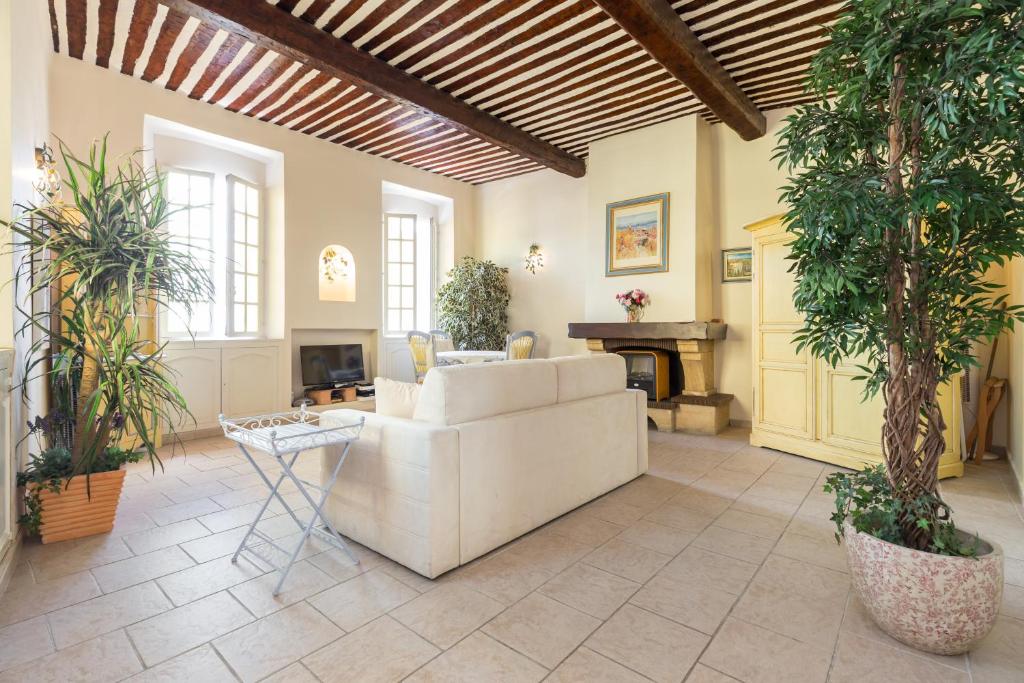 a living room with a white couch and a fireplace at Very charming studio apartment on port in Cannes a short walk to Palais with Aircon and internet 411 in Cannes