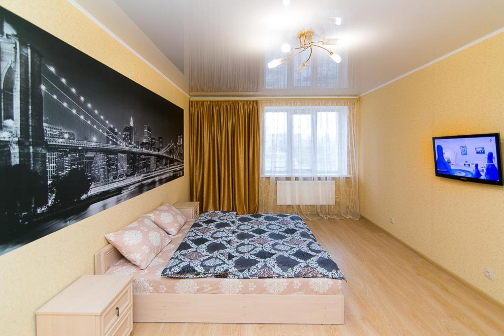 Kama o mga kama sa kuwarto sa VIP Apartment on Novomestenskaya