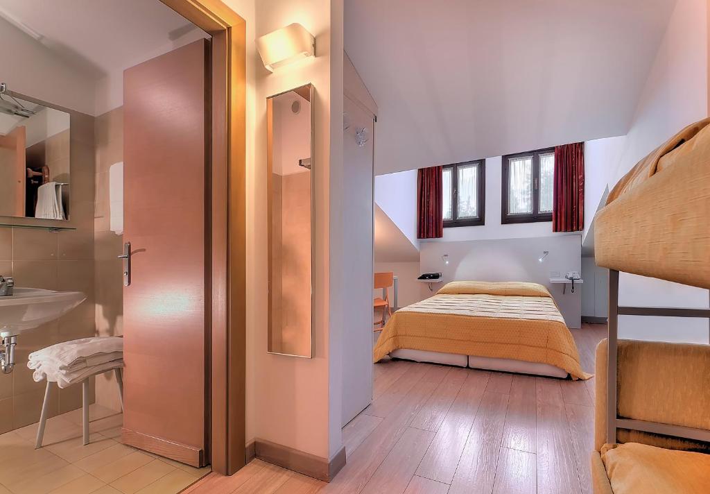 Postel nebo postele na pokoji v ubytování Hotel Alaska