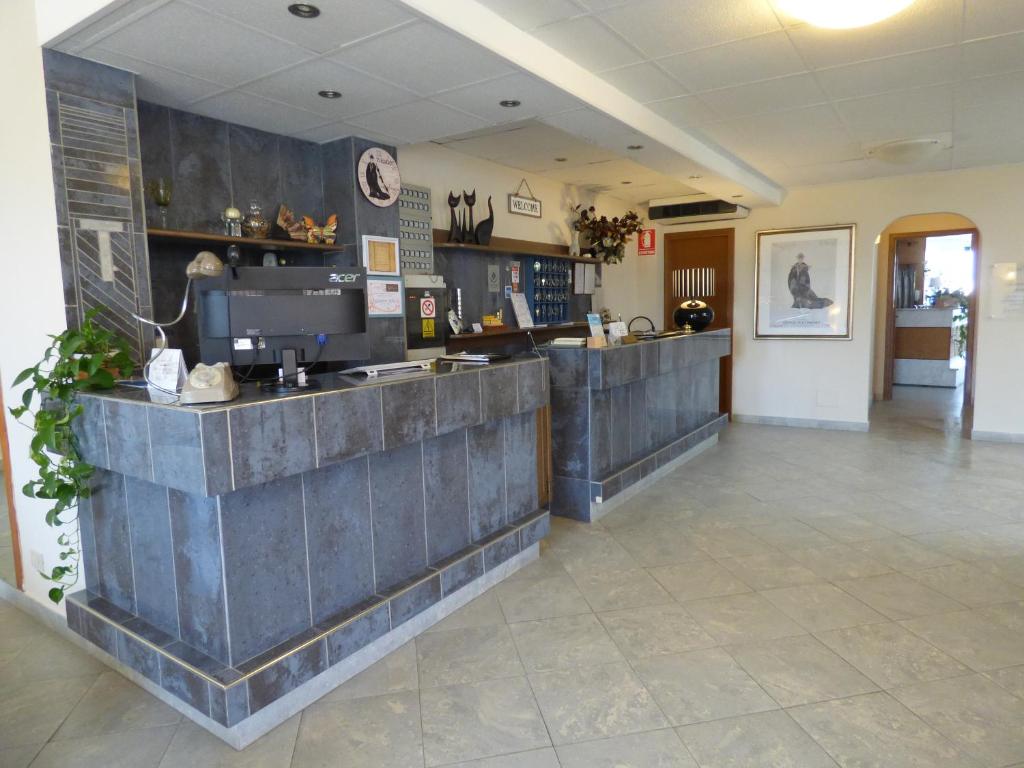 a coffee shop with a counter in a room at Hotel Turandot in Torre del Lago Puccini