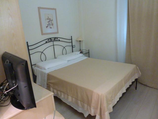 Postel nebo postele na pokoji v ubytování Hotel Sirolo
