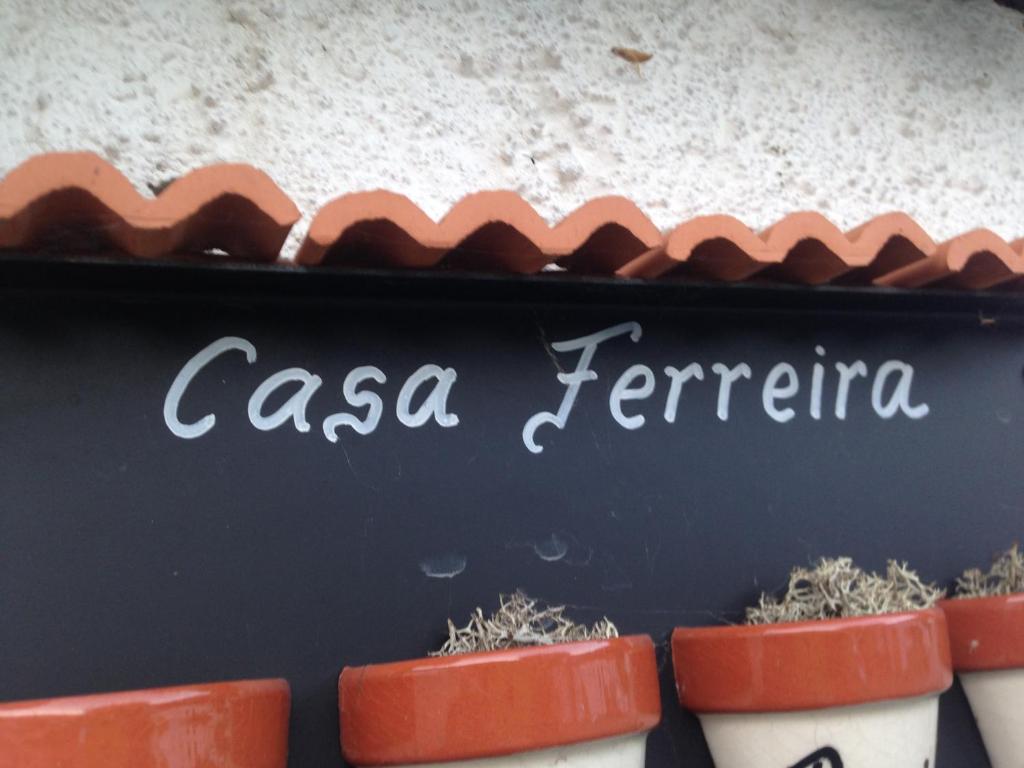 a sign that says casa ferreira next to plants at Casa Ferreira in Góis
