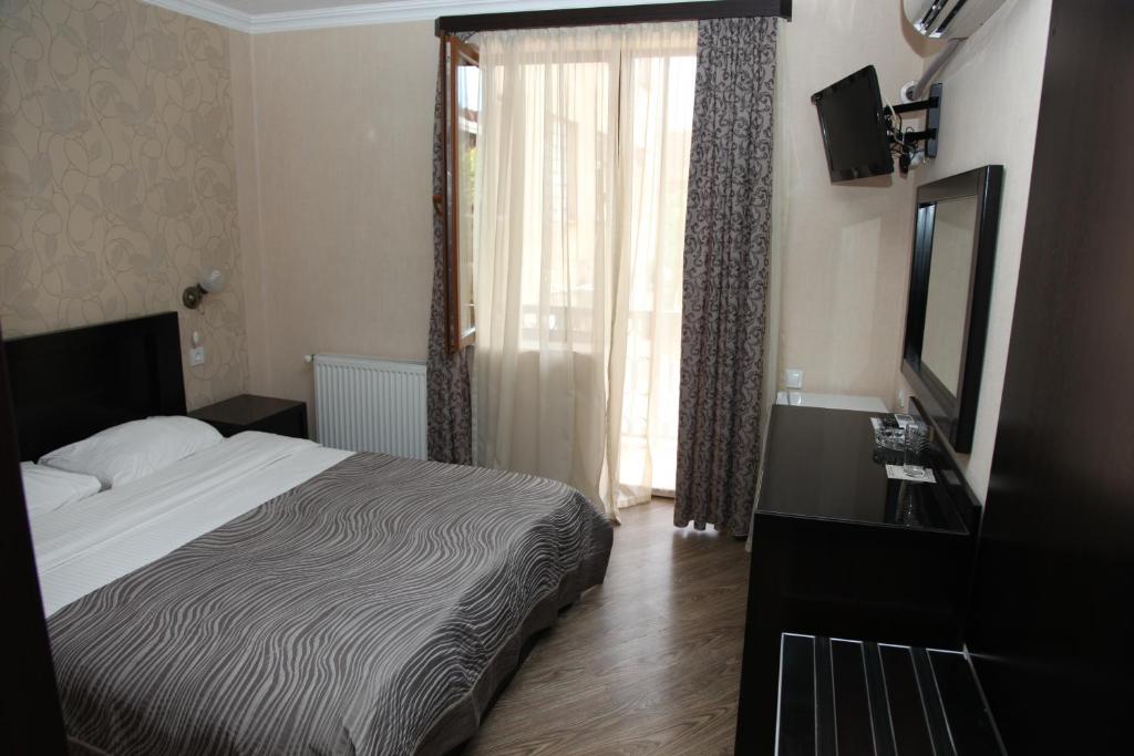 Postel nebo postele na pokoji v ubytování Hotel Obola