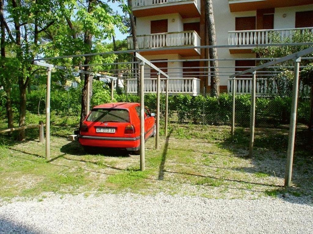 A garden outside Lignano Pineta with air conditioning&washing machine