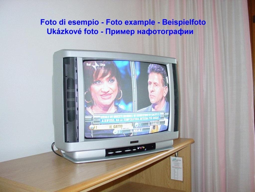 A television and/or entertainment centre at Lignano Pineta with air conditioning&washing machine