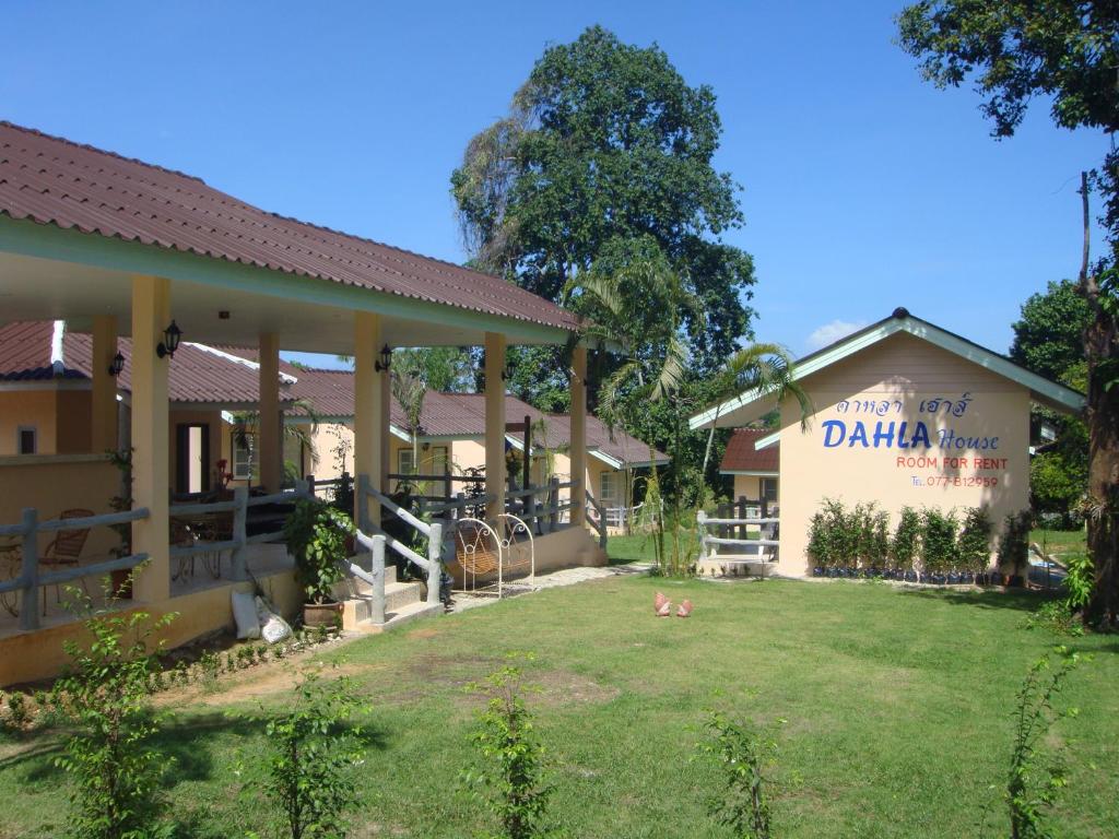 a building with a yard in front of it at Dahla House Ranong in Ranong
