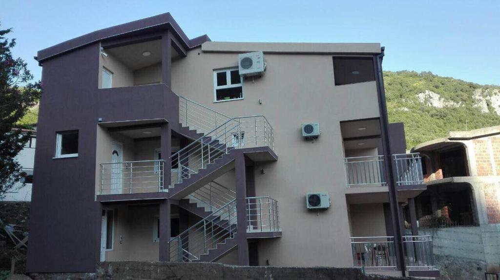 a building with balconies on the side of it at Vip Apartmani Canj in Čanj