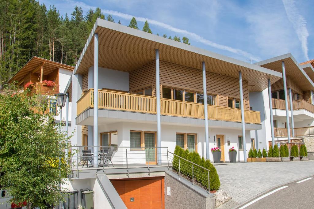 an apartment building with a balcony on a street at Ciasa Dolomites in La Villa