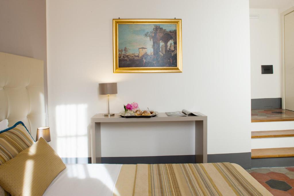 Postel nebo postele na pokoji v ubytování Antico Angelo - Residenza d'Epoca