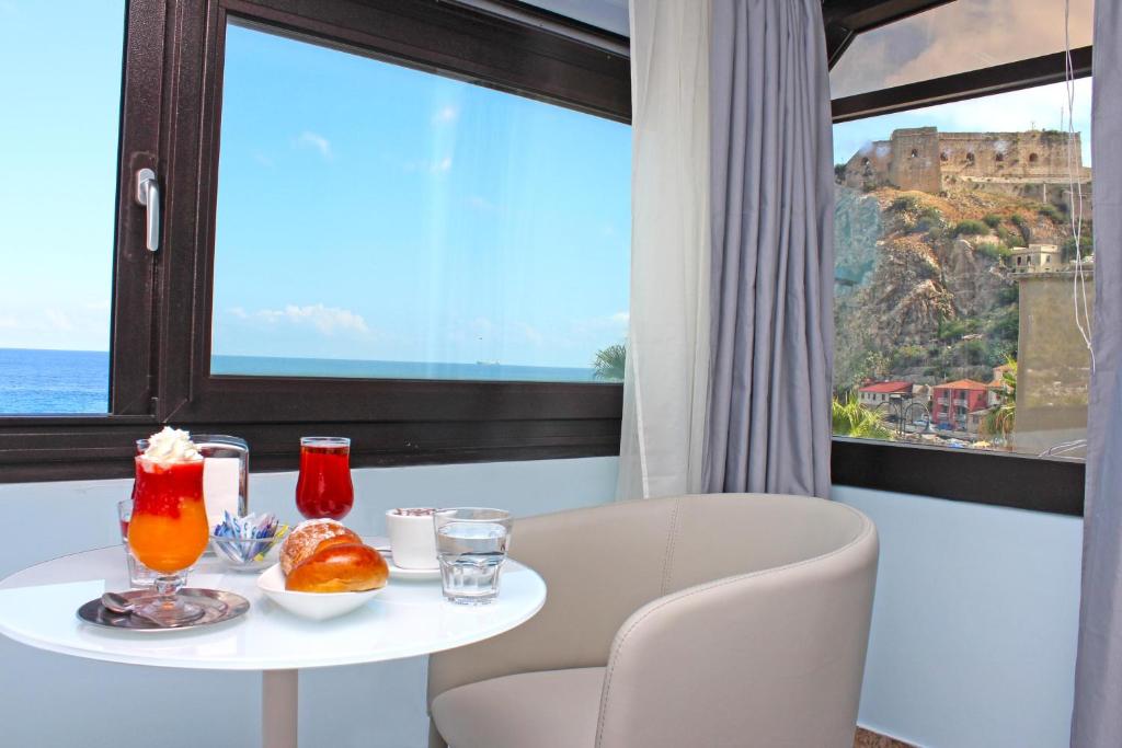 a table with food and drinks in a room with a window at BB Oasis in Scilla