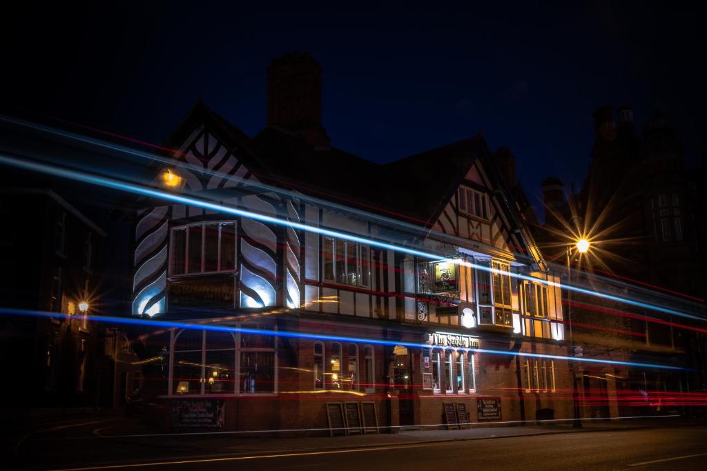 a building with lights on it at night at The Saddle Inn in Chester