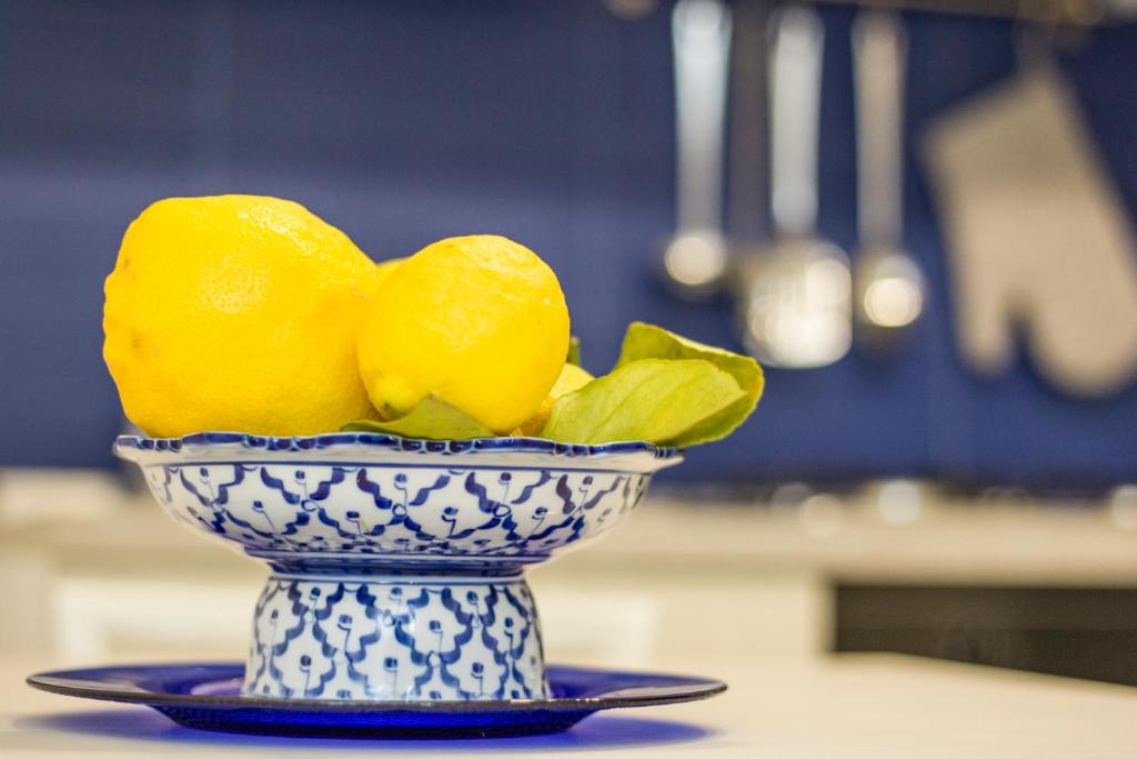 a blue and white bowl with lemons in it at Capri Blue in Capri