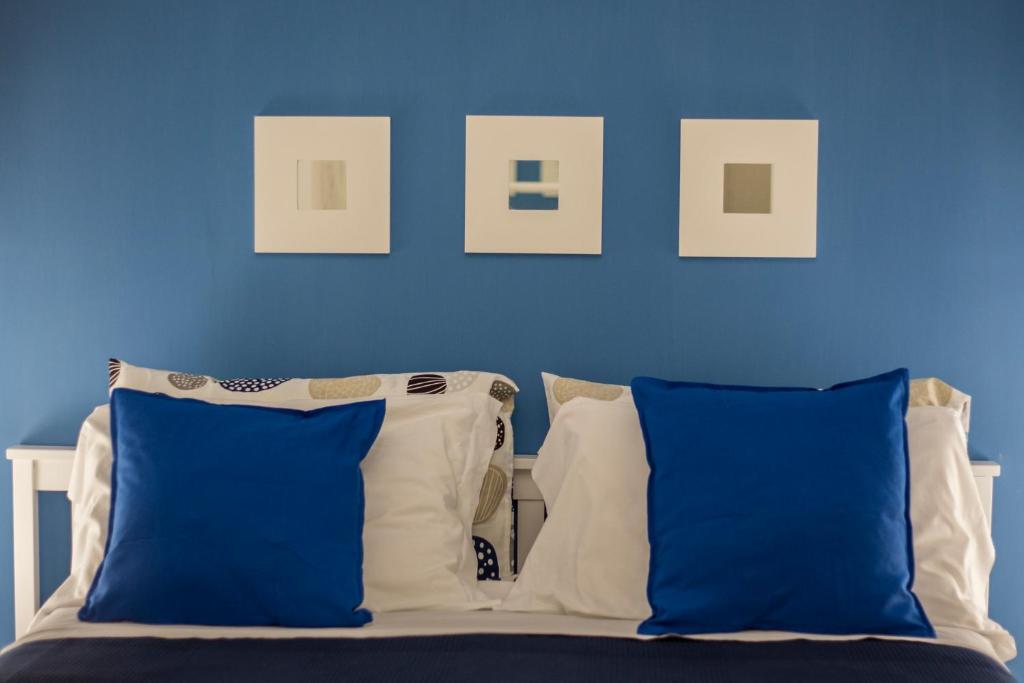 a blue bedroom with a bed with blue walls and pillows at Capri Blue in Capri