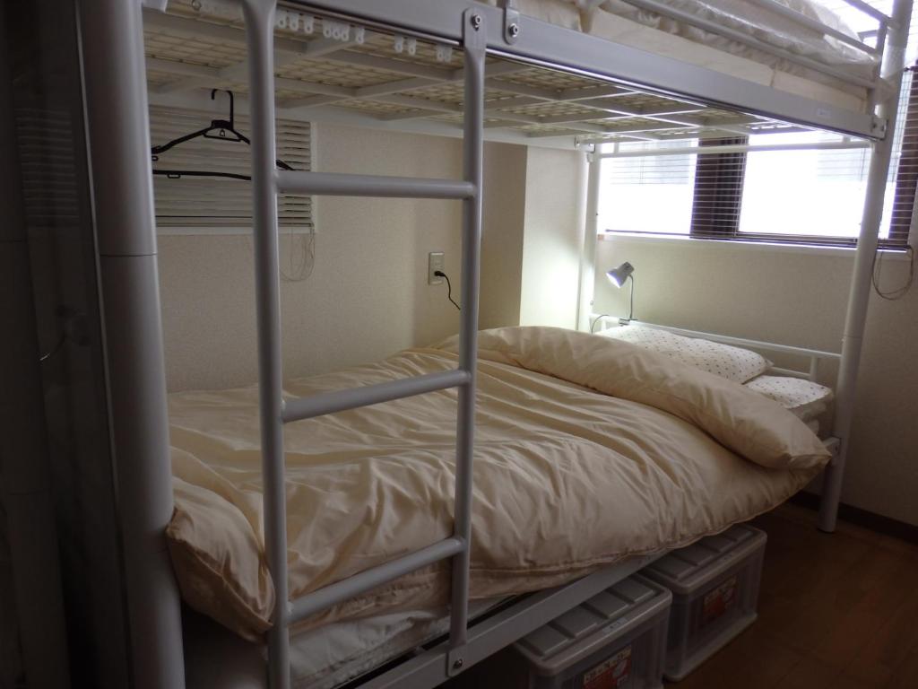 Postel nebo postele na pokoji v ubytování Backpacker's Mini House