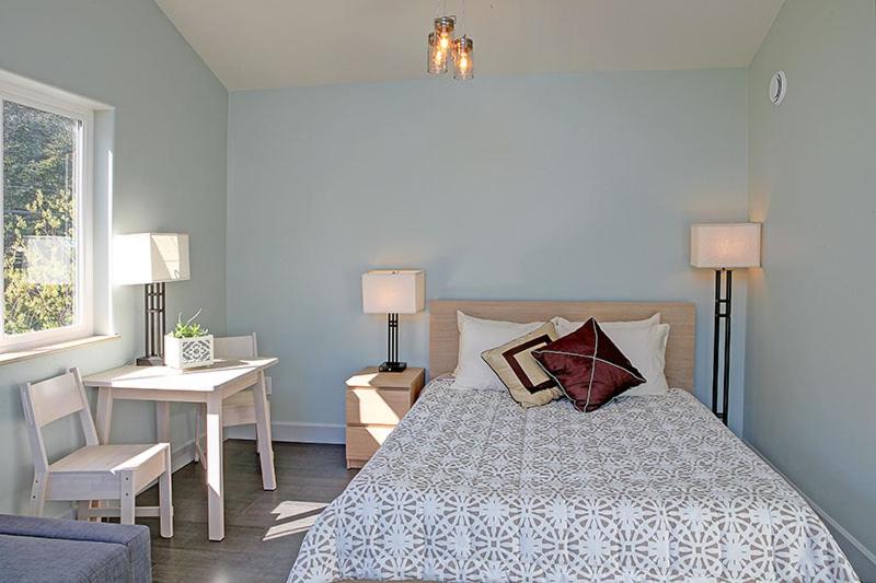 a bedroom with a bed and a table and a desk at The Vue B&B in Seward