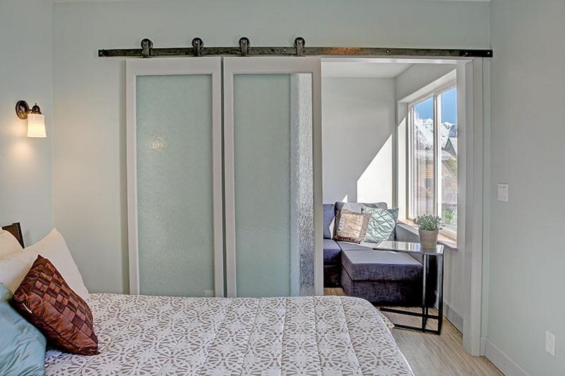 a bedroom with a bed and a couch and a window at The Vue B&B in Seward