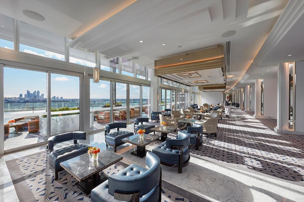 a hotel lobby with couches and tables and windows at Crown Towers Perth in Perth