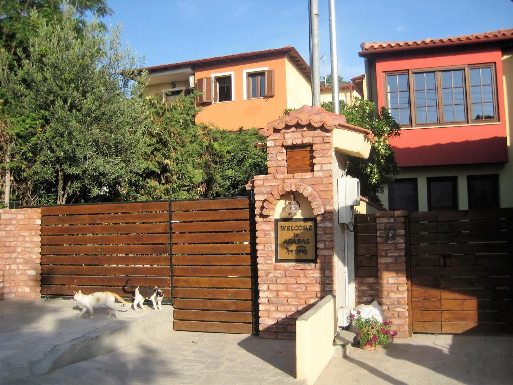 dois cães estão andando em frente a uma cerca em Studios Arabas em Tessalônica