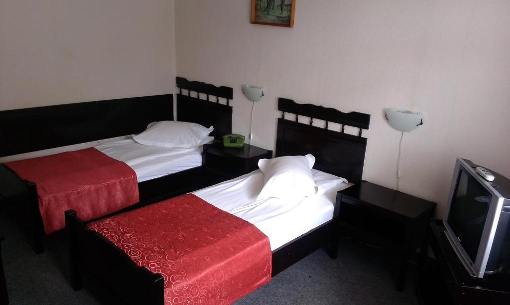 Postel nebo postele na pokoji v ubytování Hotel Tusnad