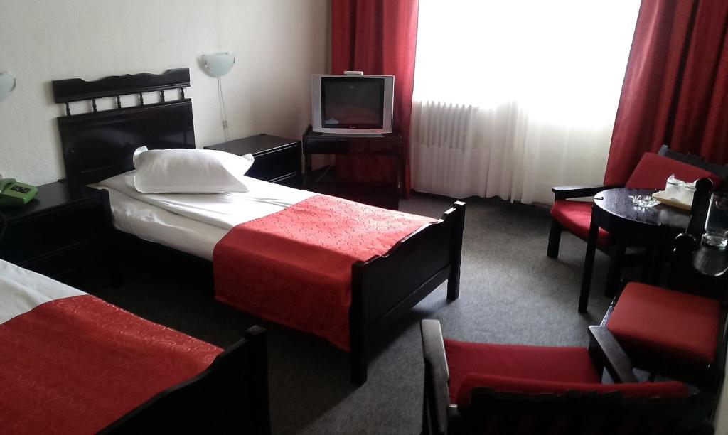 Postel nebo postele na pokoji v ubytování Hotel Tusnad