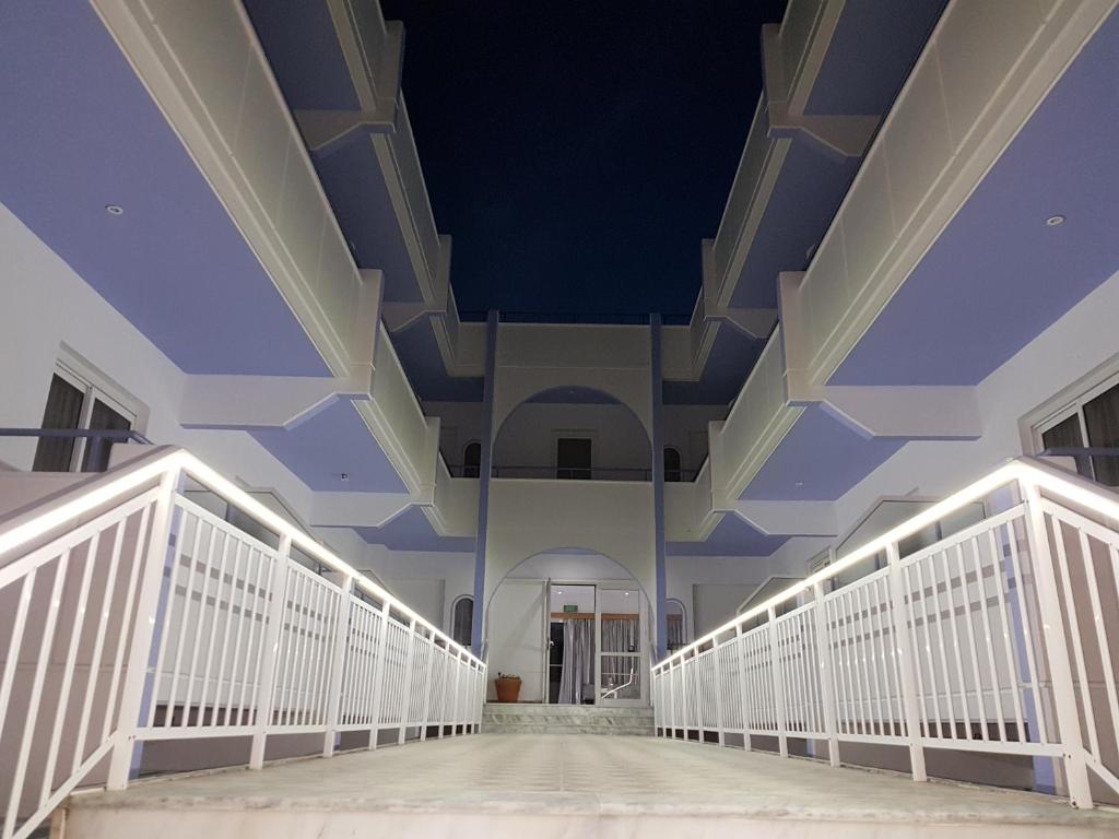 an empty hallway of a building with blue ceilings at Pyrgos Hotel Apartments in Kremasti