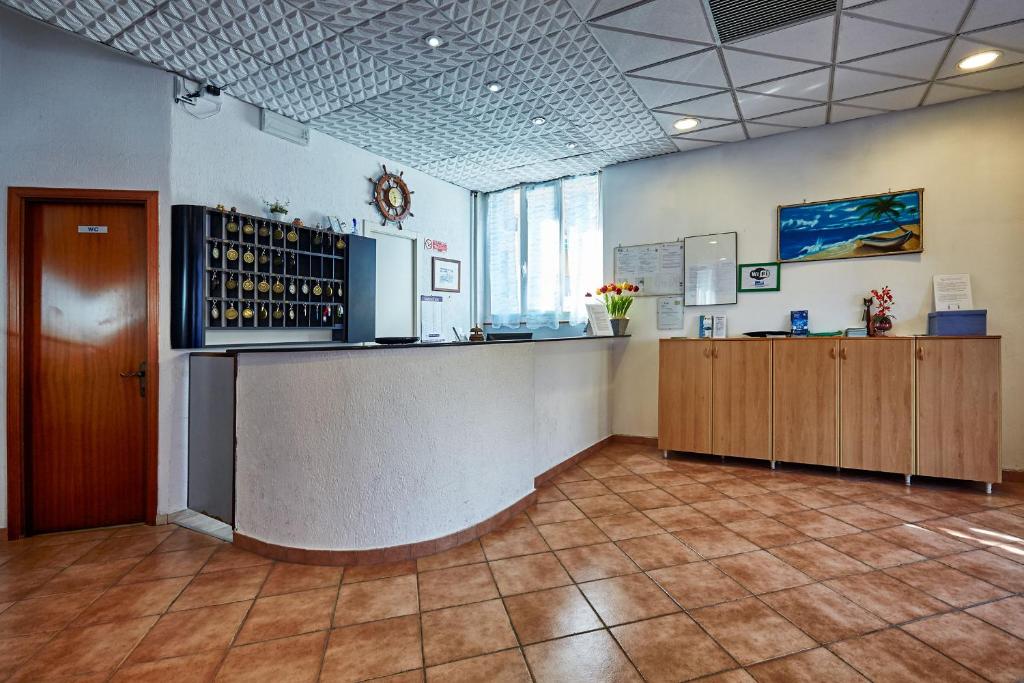 a large room with a bar in a wine shop at Hotel Palace in Finale Ligure