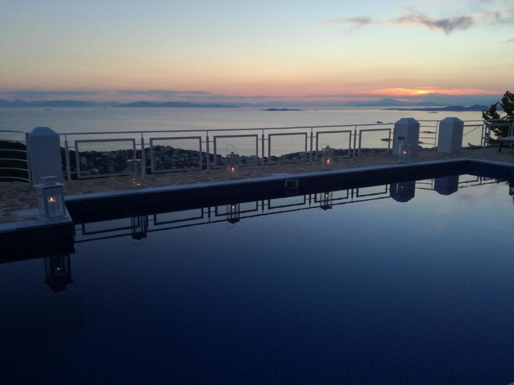 un puente sobre un cuerpo de agua al atardecer en Infinity Blue Suite, en Saronida