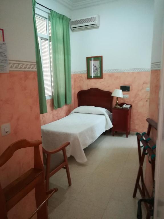 Postel nebo postele na pokoji v ubytování Nuevo Hotel
