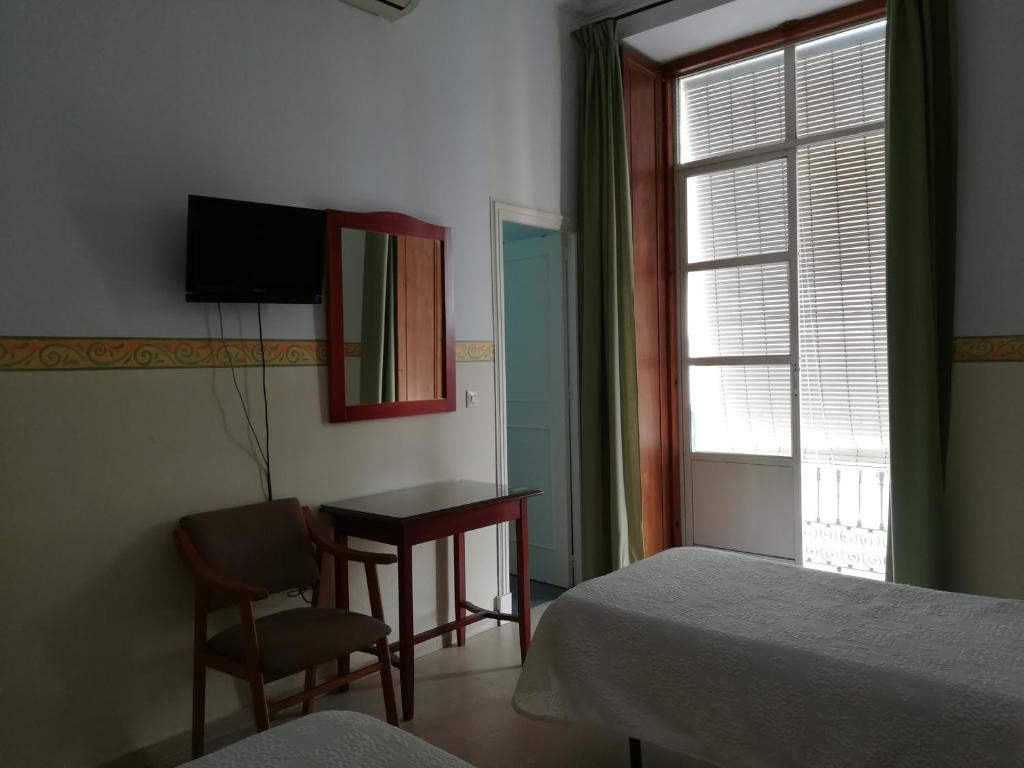 Postel nebo postele na pokoji v ubytování Nuevo Hotel