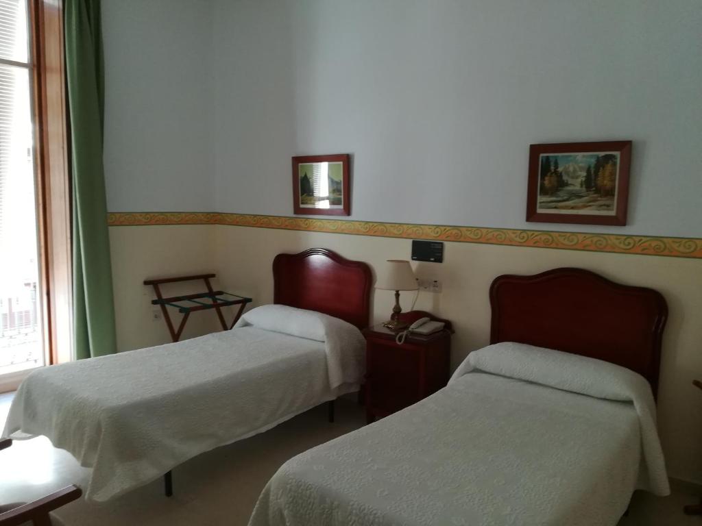 Postel nebo postele na pokoji v ubytování Nuevo Hotel