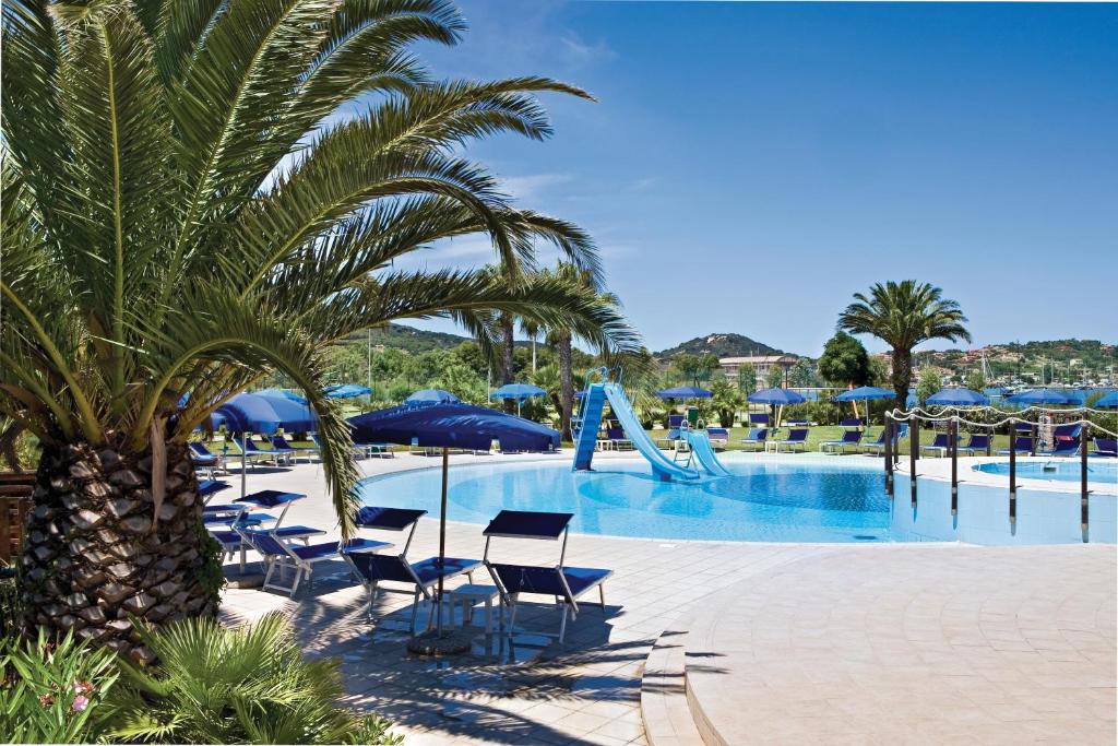a pool with chairs and a slide at a resort at Hotel Airone isola d'Elba in Portoferraio