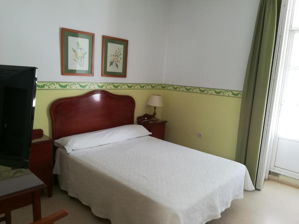 Postel nebo postele na pokoji v ubytování Nuevo Hotel