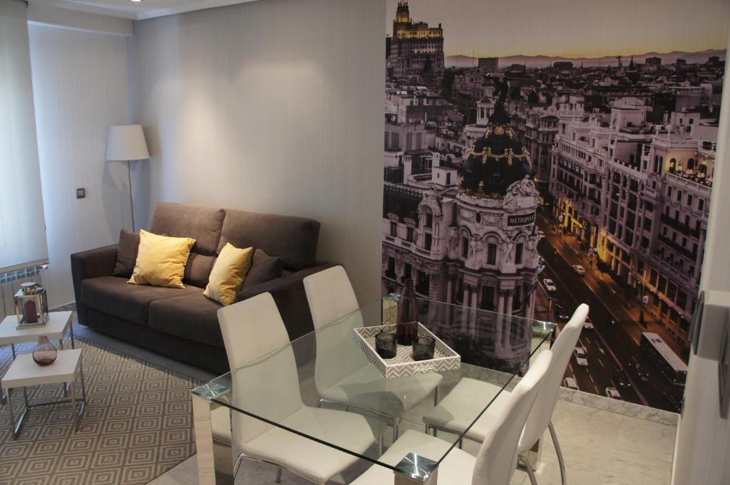 a living room with a glass table and a couch at Arizonica Suites in Madrid