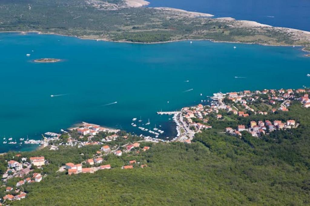 an aerial view of a small town next to a body of water at Apartments Mestrovic, Klimno, Soline bay, island Krk in Klimno