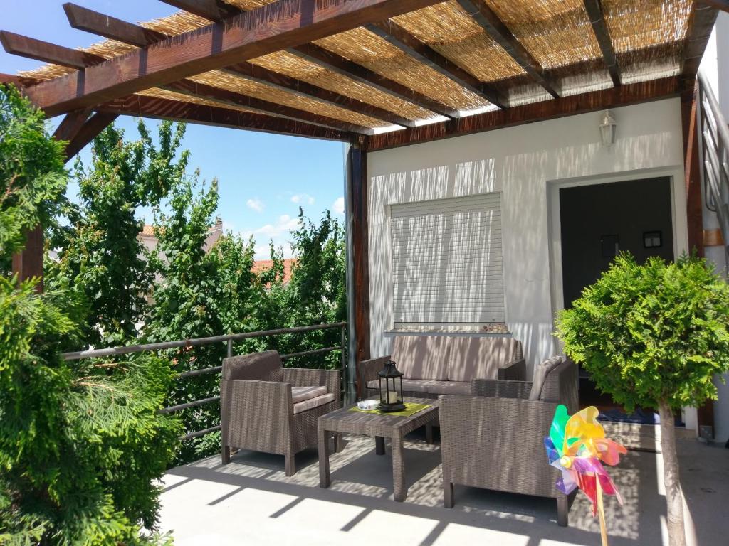 a patio with a table and chairs and a pergola at Apartment Karma in Zadar